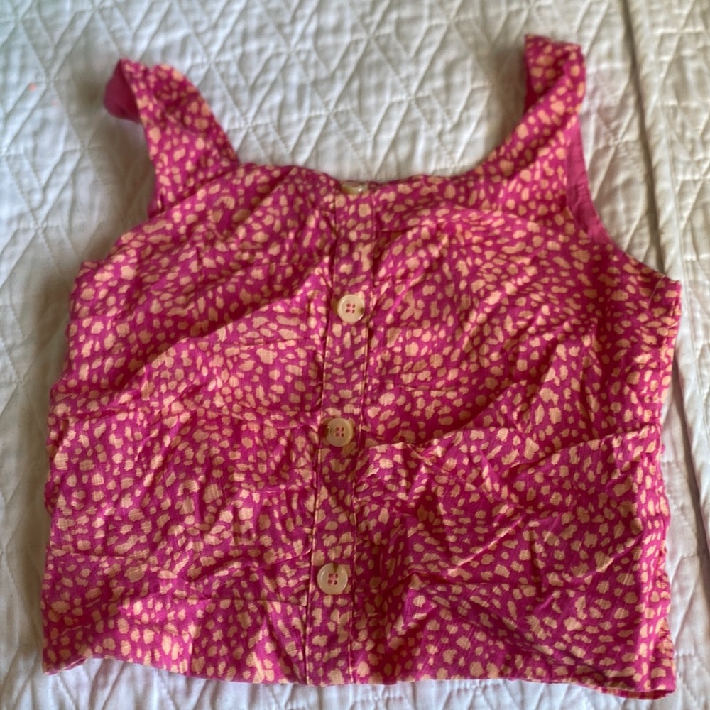 pink shirt with tan buttons